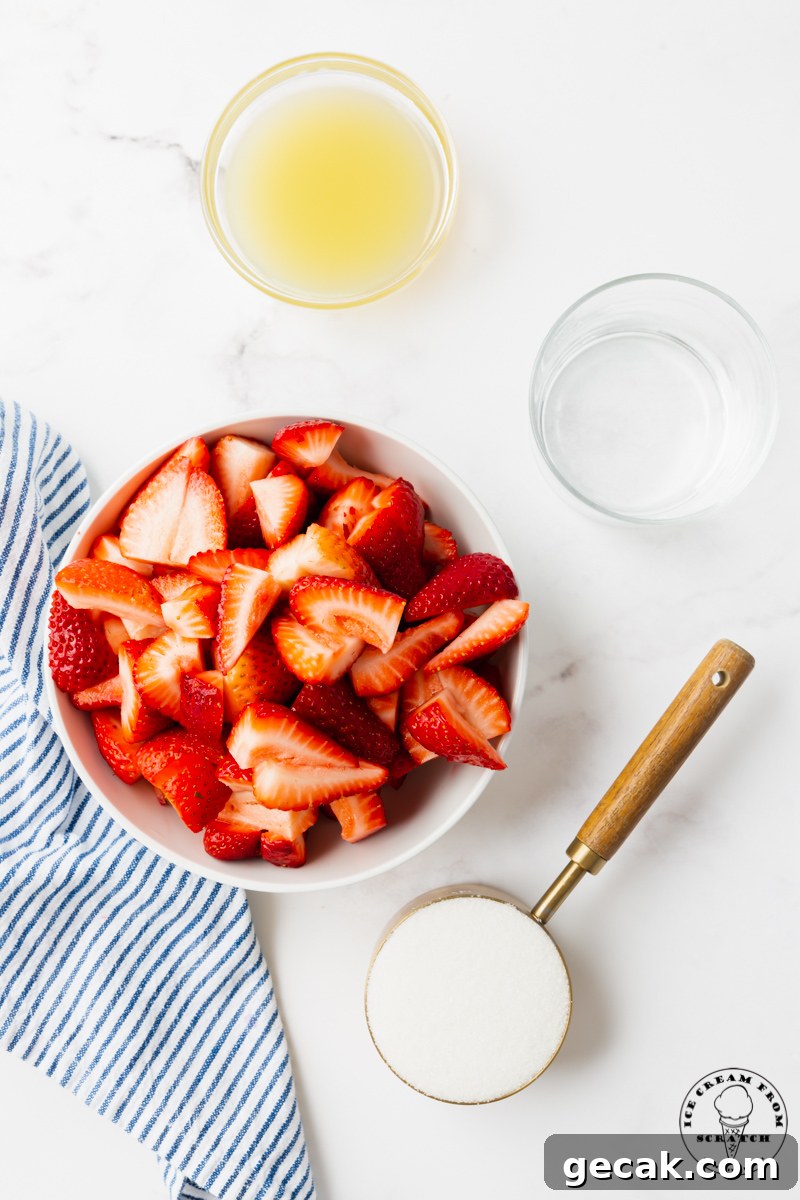 The ingredients needed to make strawberry popsicles, including berries, sugar, and lemon juice, measured into separate bowls, viewed from above.