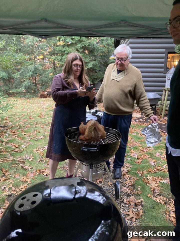 Teri & Roy looking at turkey on grill