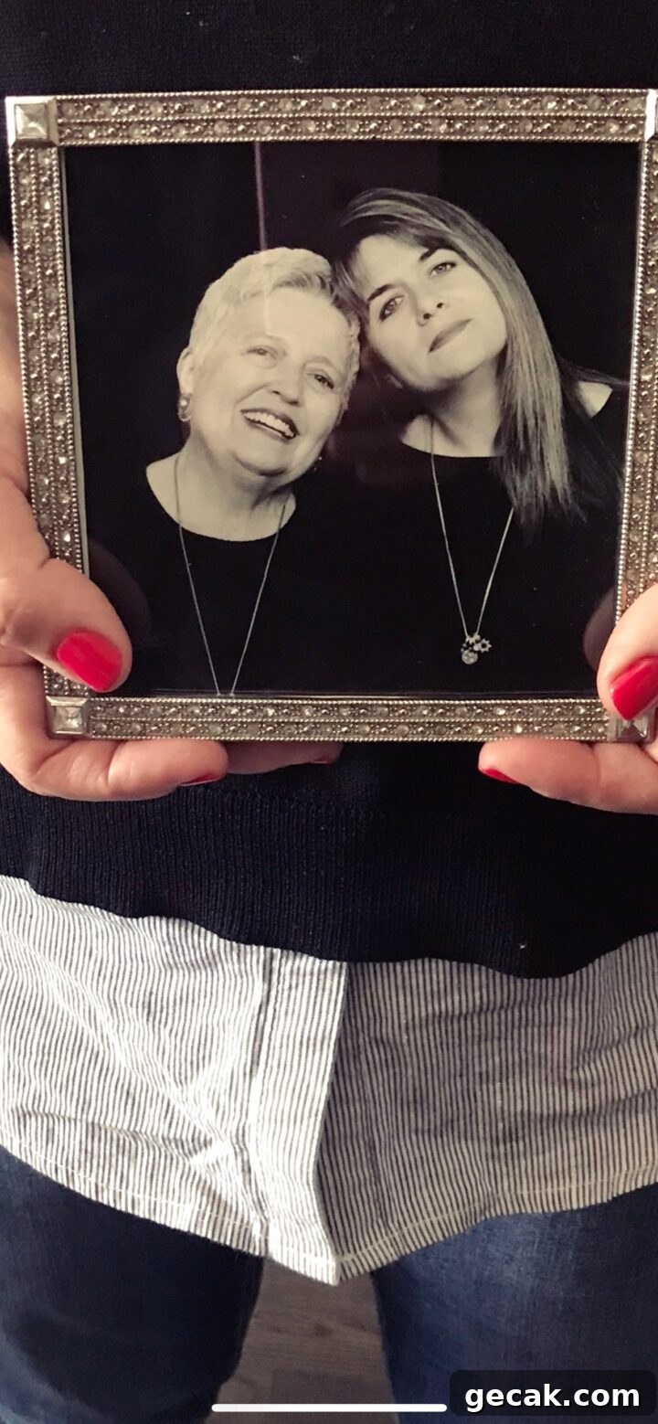 Teri holding a photo of her & her mom