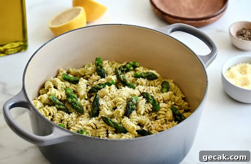 Creamy Asparagus Pesto Pasta with Parmesan 6 Creamy asapagus pesto pasta garnished with asparagus spears and Parmesan cheese in a large stockpot