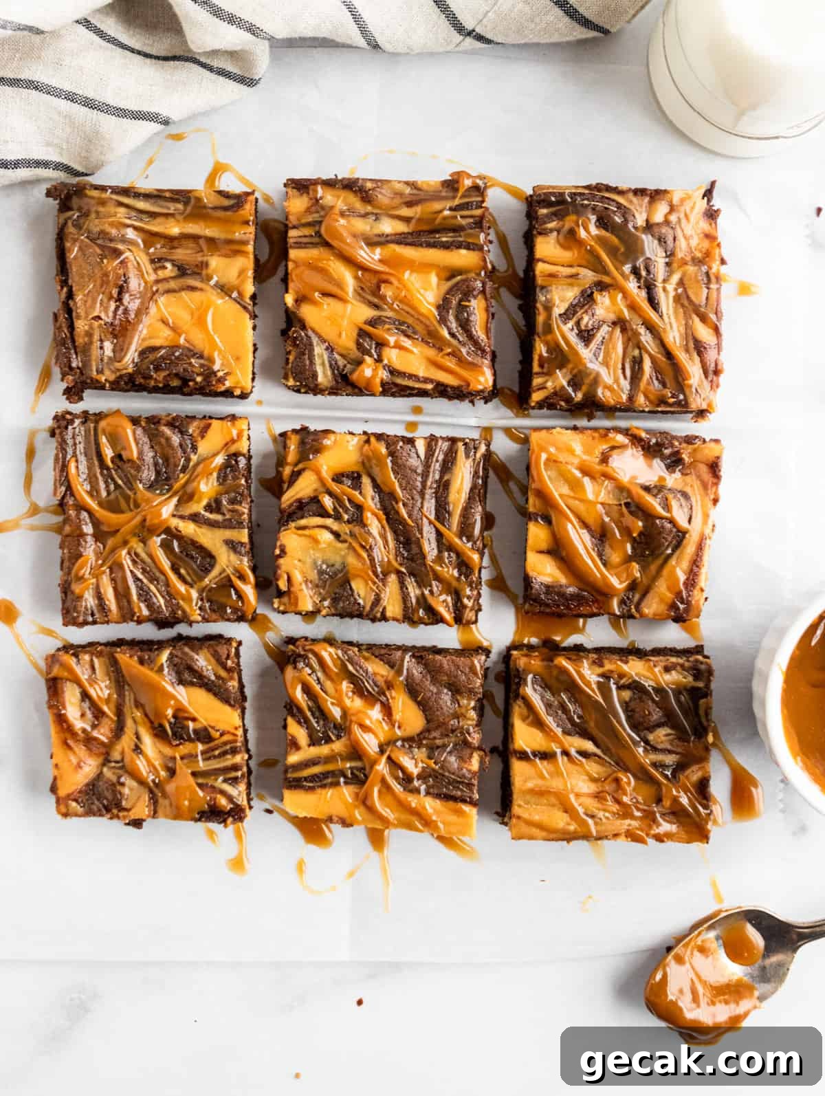 Salted Dulce de Leche Cream Cheese Brownies Recipe 3 Overhead shot of sliced brownies with dulce de leche drizzle.