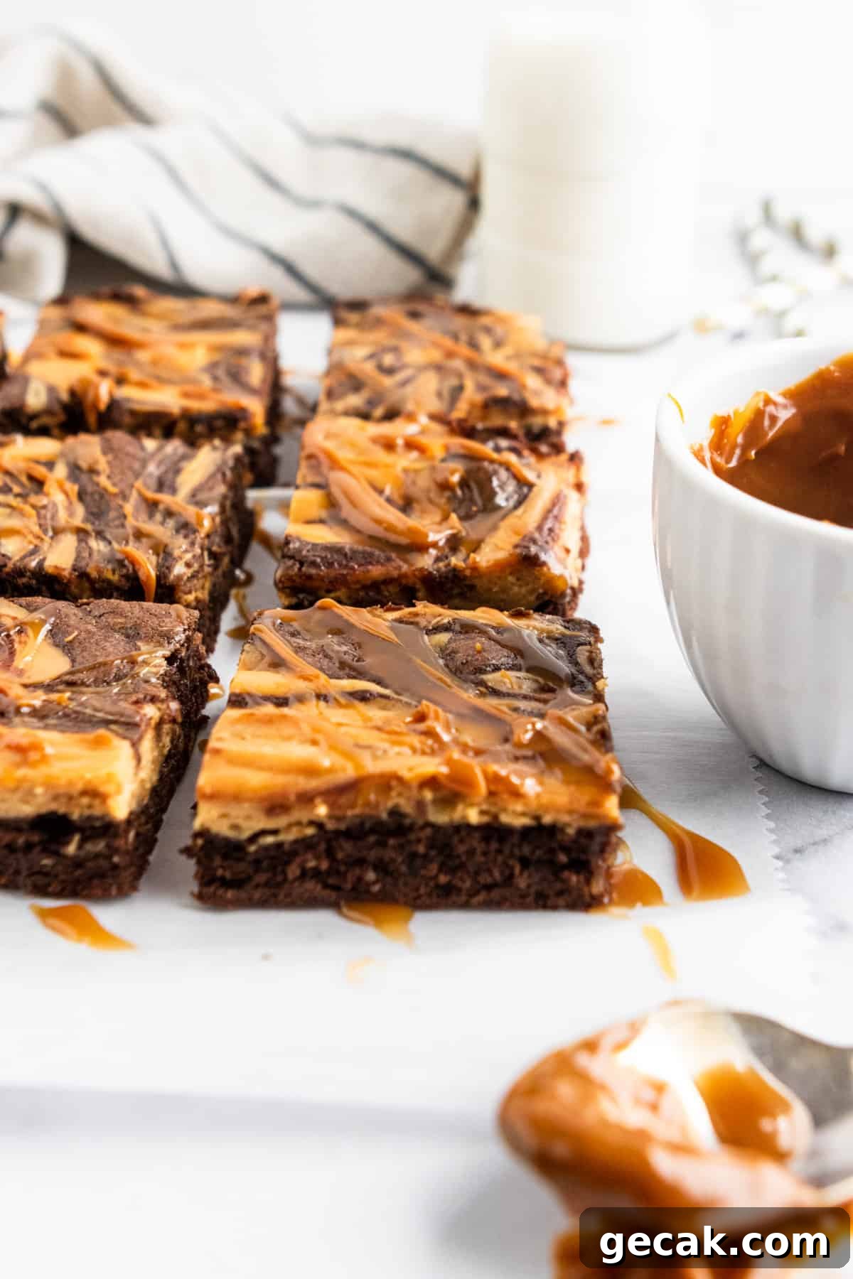 Salted Dulce de Leche Cream Cheese Brownies Recipe 4 Sliced brownies with drizzle.
