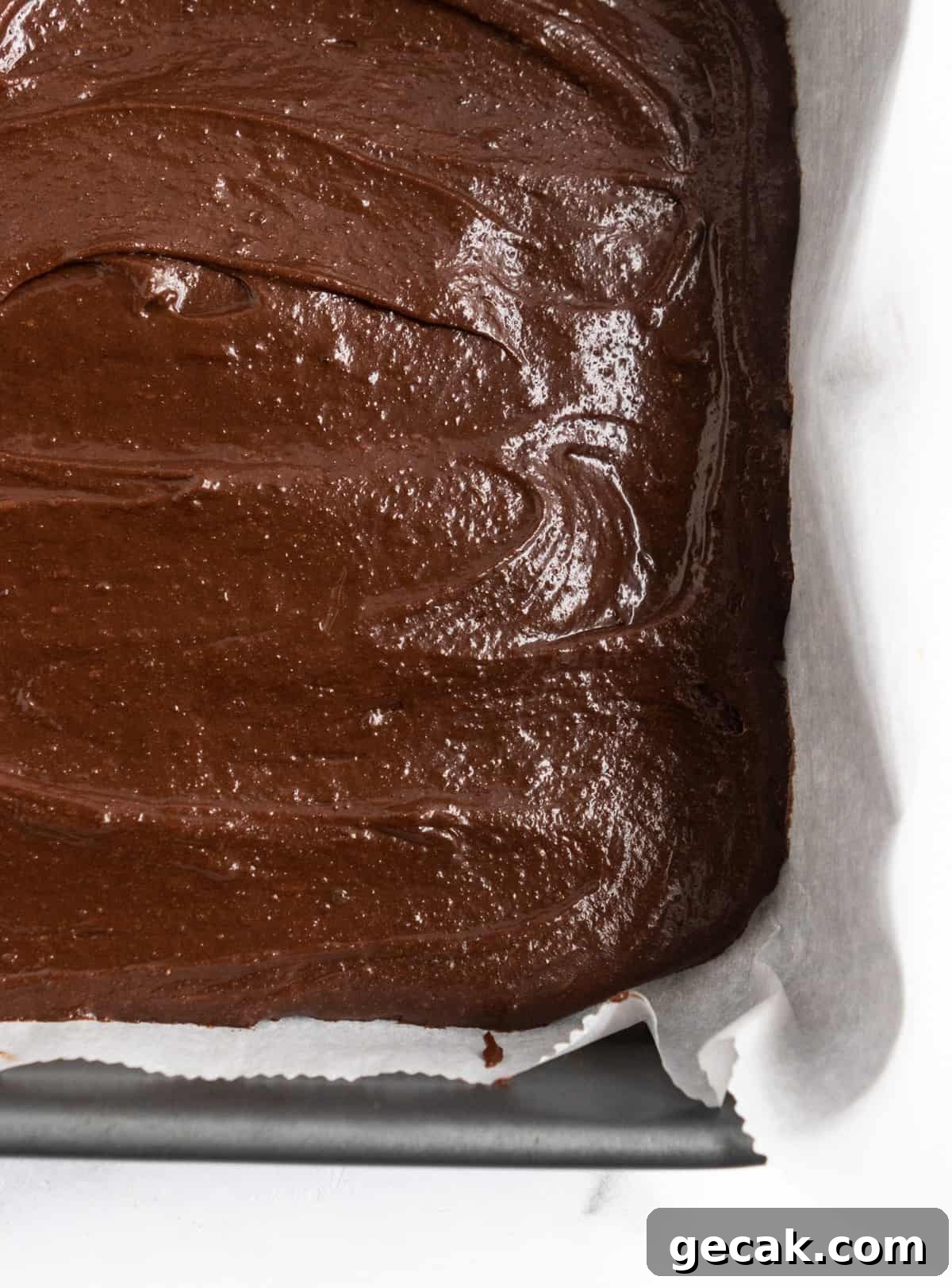 Salted Dulce de Leche Cream Cheese Brownies Recipe 7 Brownie batter in parchment lined pan.