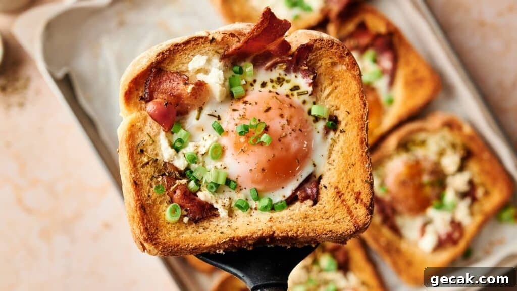 A slice of toasted bread with a cooked egg in the center, topped with bacon, green onions, and herbs, held above a tray of similar pieces.