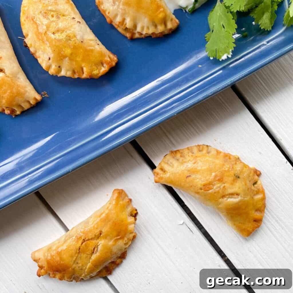 empanadas on a blue plate and white table