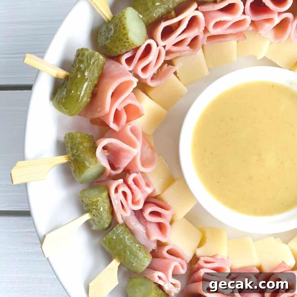 mini cubanos on a stick with cheese, pickles and ham