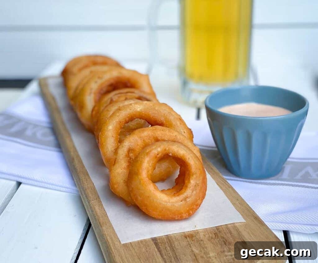 beer battered onion rings on cutting board.