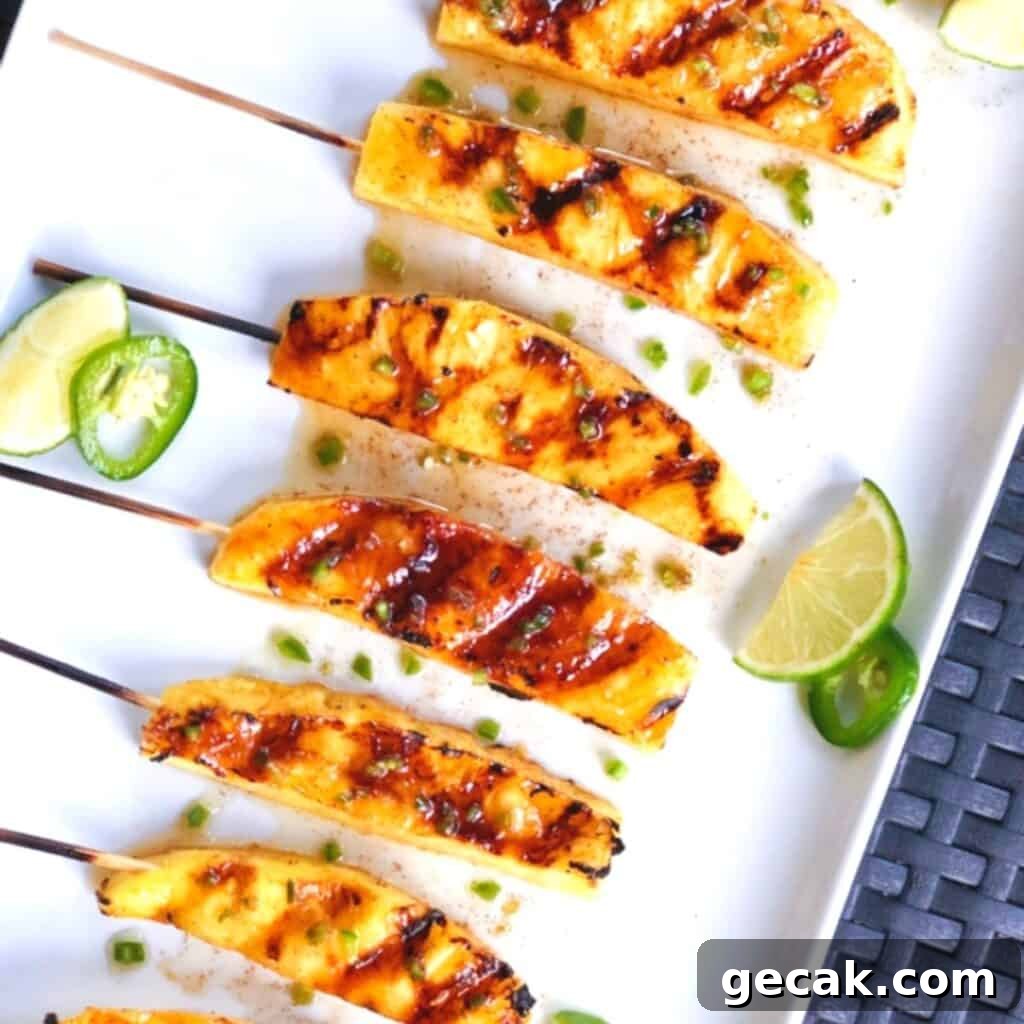 Grilled pineapple spears on a plate.