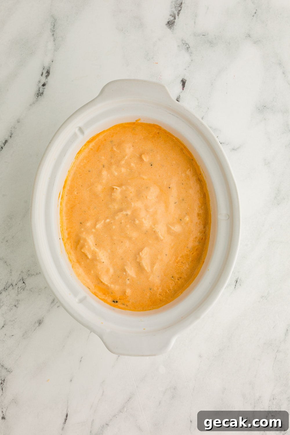 Slow Cooker Buffalo Chicken Dip: Creamy Cheesy Party Recipe 7 Cheesy Slow Cooker Buffalo Chicken Dip mixture in slow cooker in process of cooking