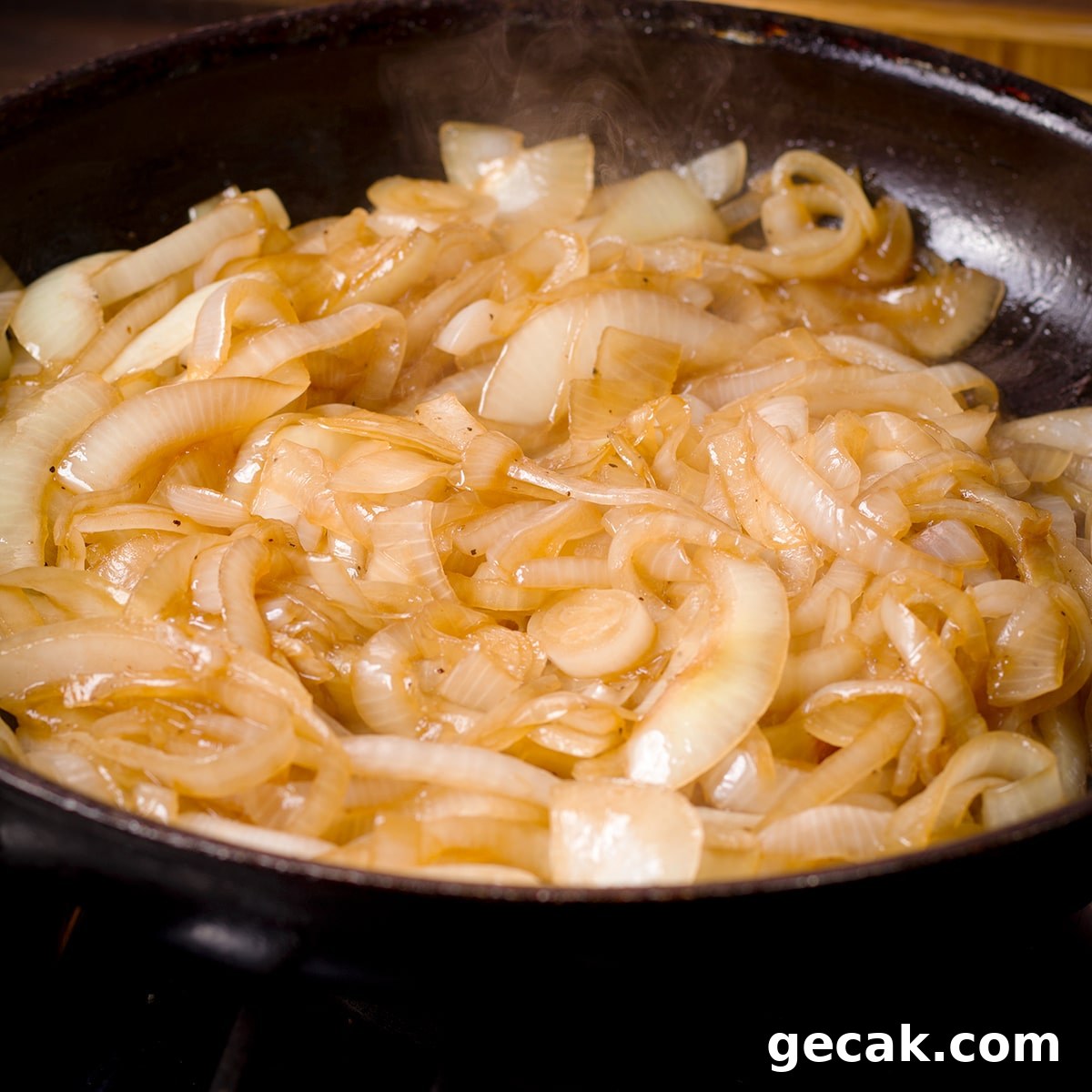 Sliced onions cooking in a hot skillet.