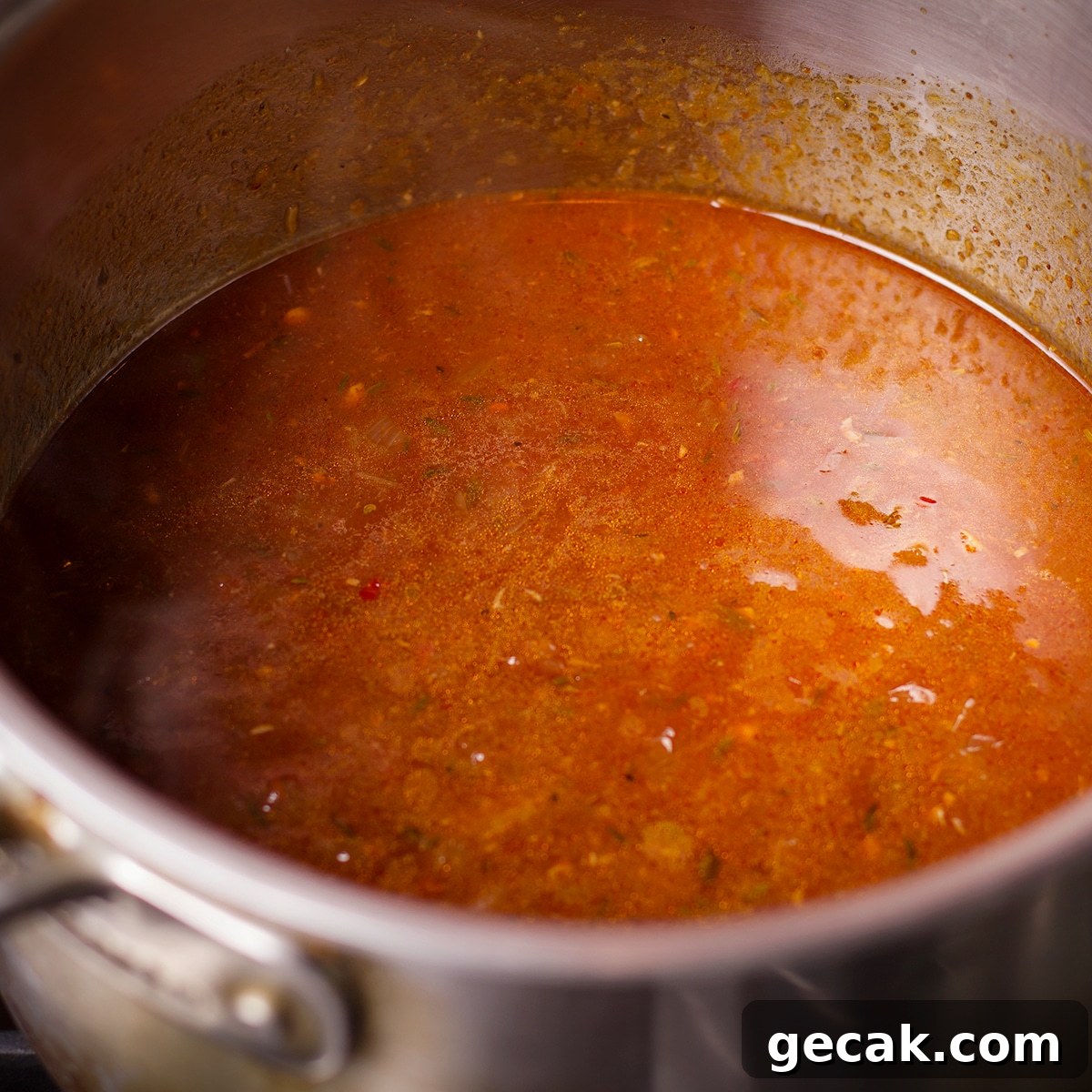 Brisket sauce warming in a sauce pan with the cooked onions. 