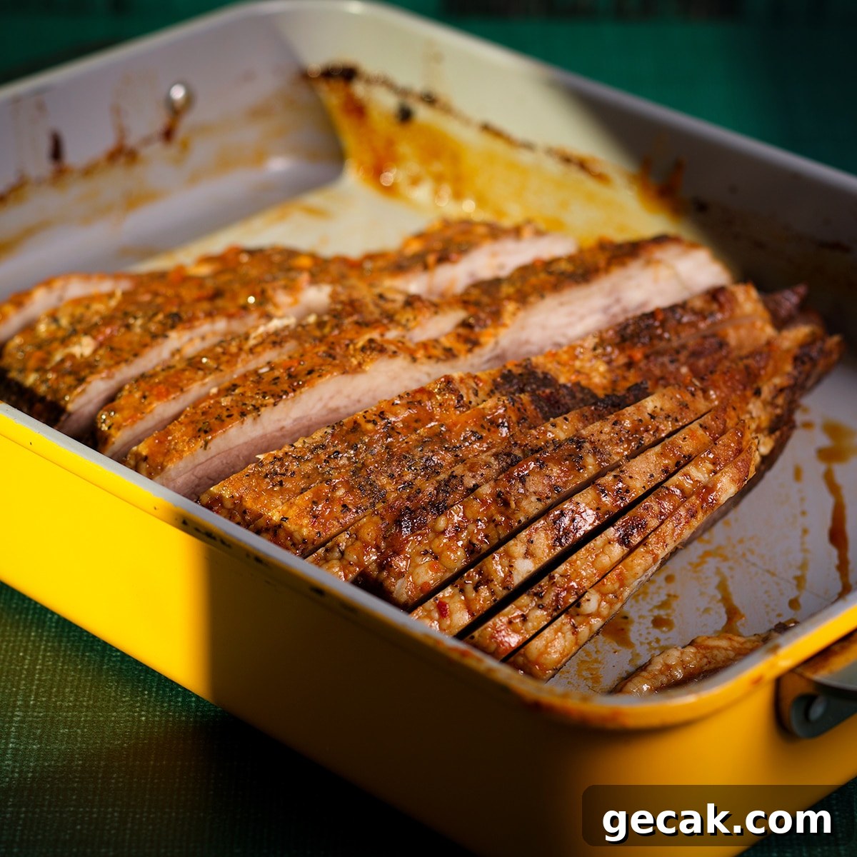 A cooked, sliced brisket inside a baking dish.