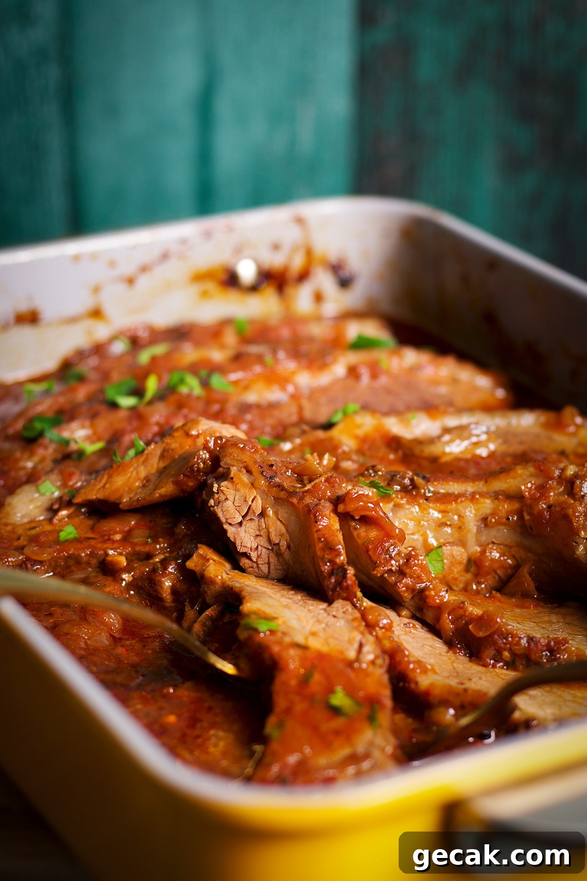A pan of braised beef brisket, hot from the oven and ready to eat.