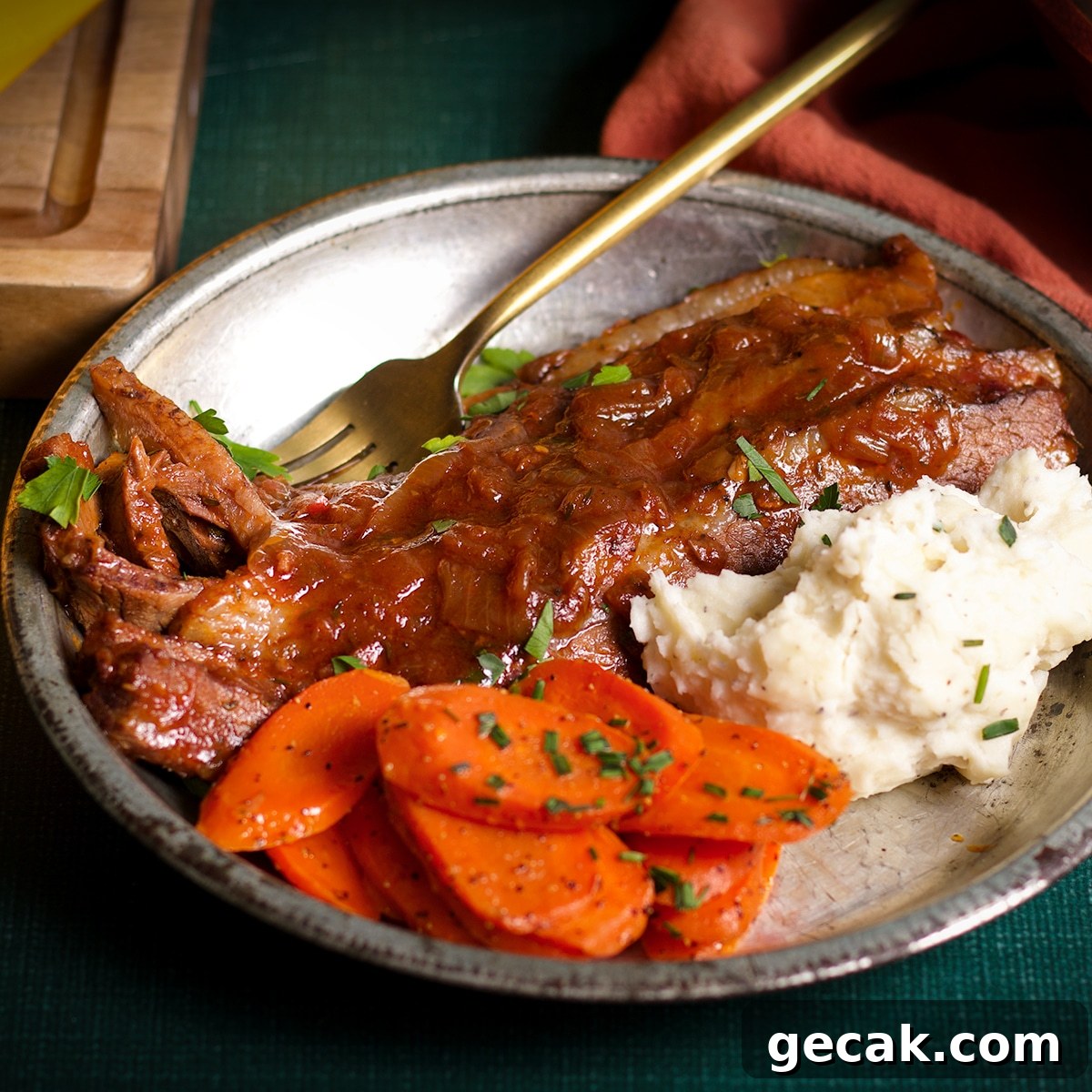 A plate filled with braised beef brisket, brown butter carrots, and buttermilk whipped potatoes.