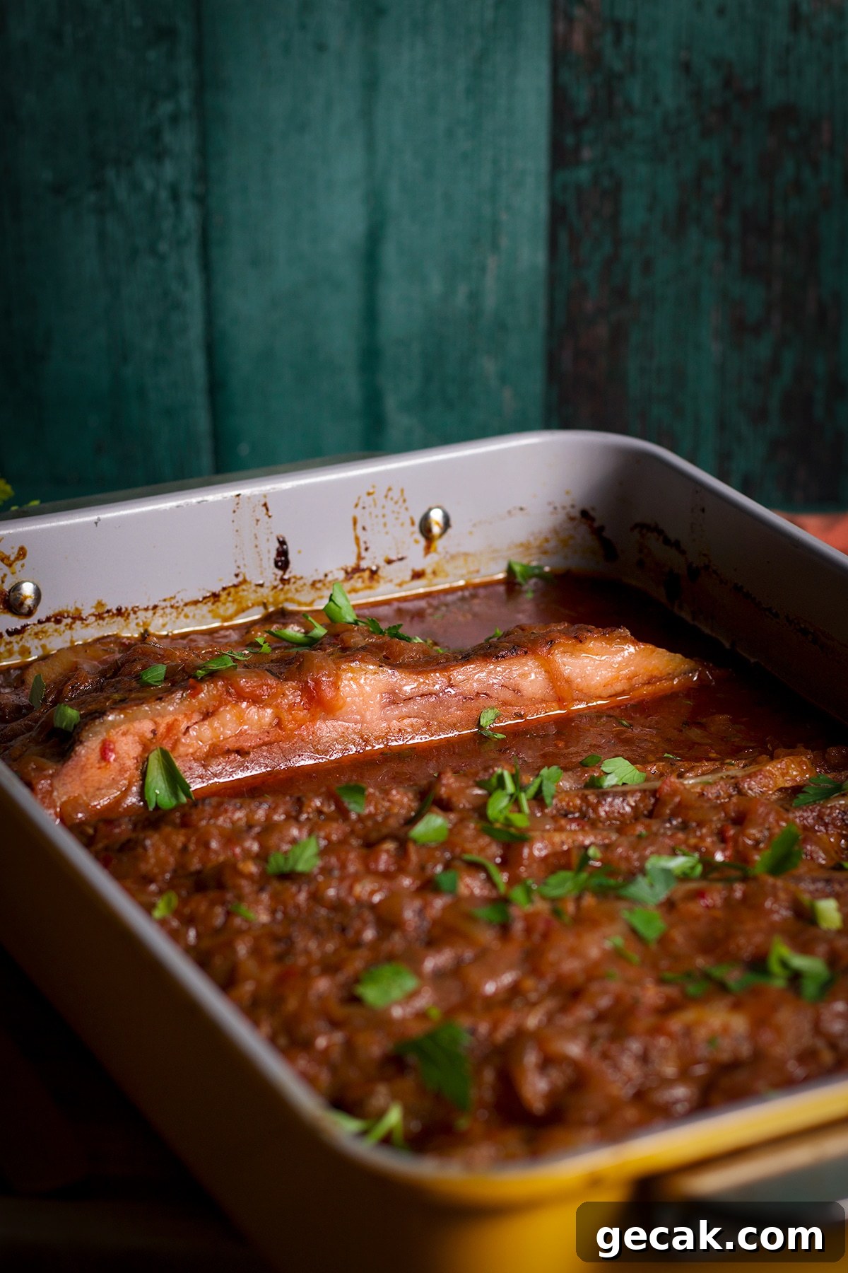 A pan of braised beef brisket, hot from the oven, and ready to serve.