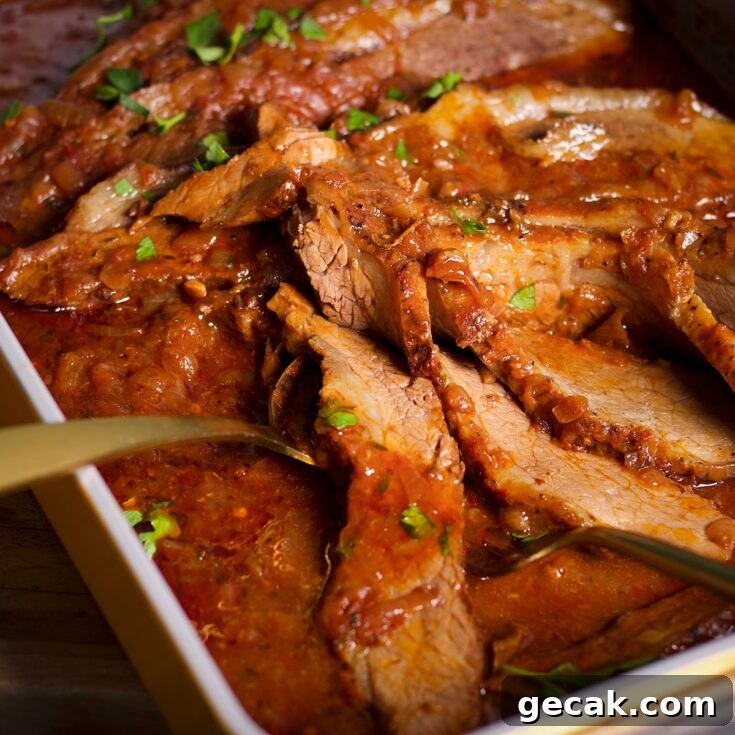 A pan of braised beef brisket, hot from the oven and ready to eat.