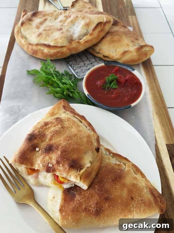 Title.Homemade Calzone cut open and on cutting board