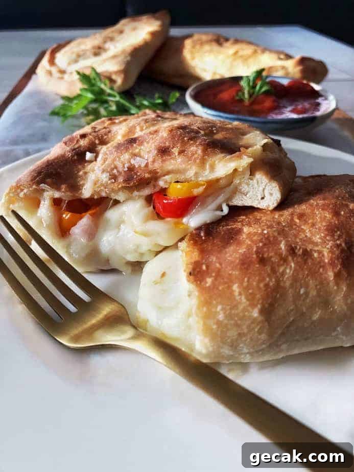 Calzone cut open with filling and fork.