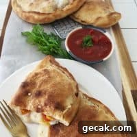 Title.Homemade Calzone cut open and on cutting board