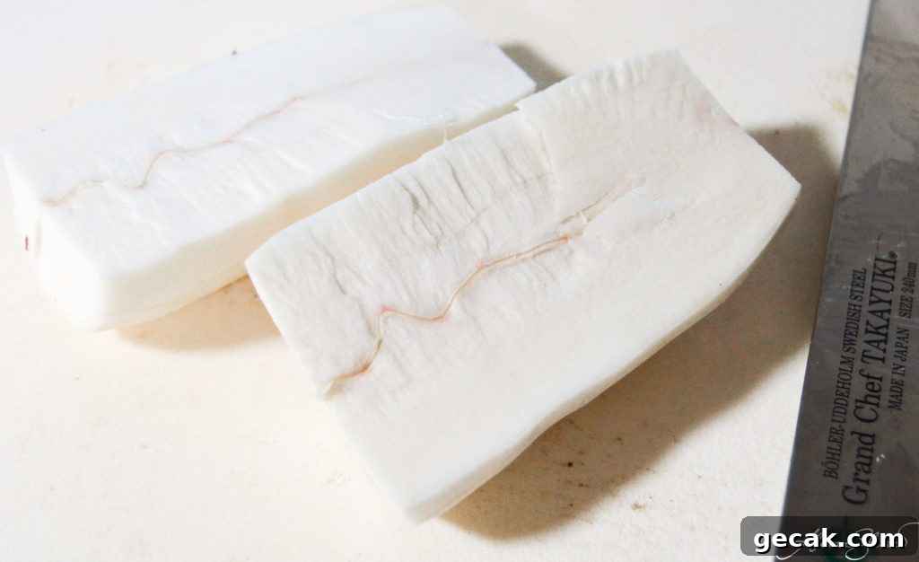 Halved peeled yuca on a cutting board