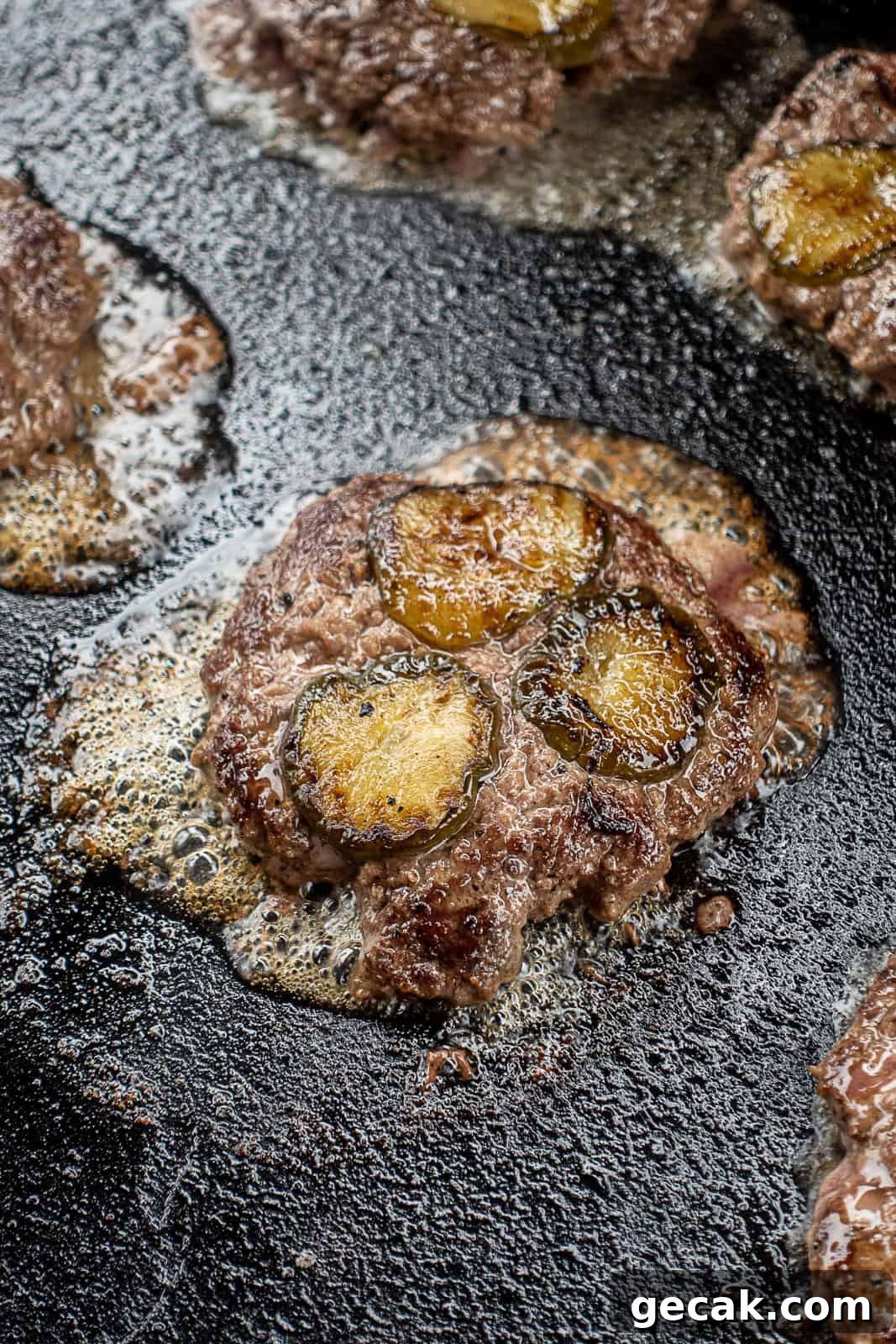 Griddled Pickle Smash Burgers with Crispy Edges 7 Closeup of Griddle Cooking Smash Burgers with Pickles