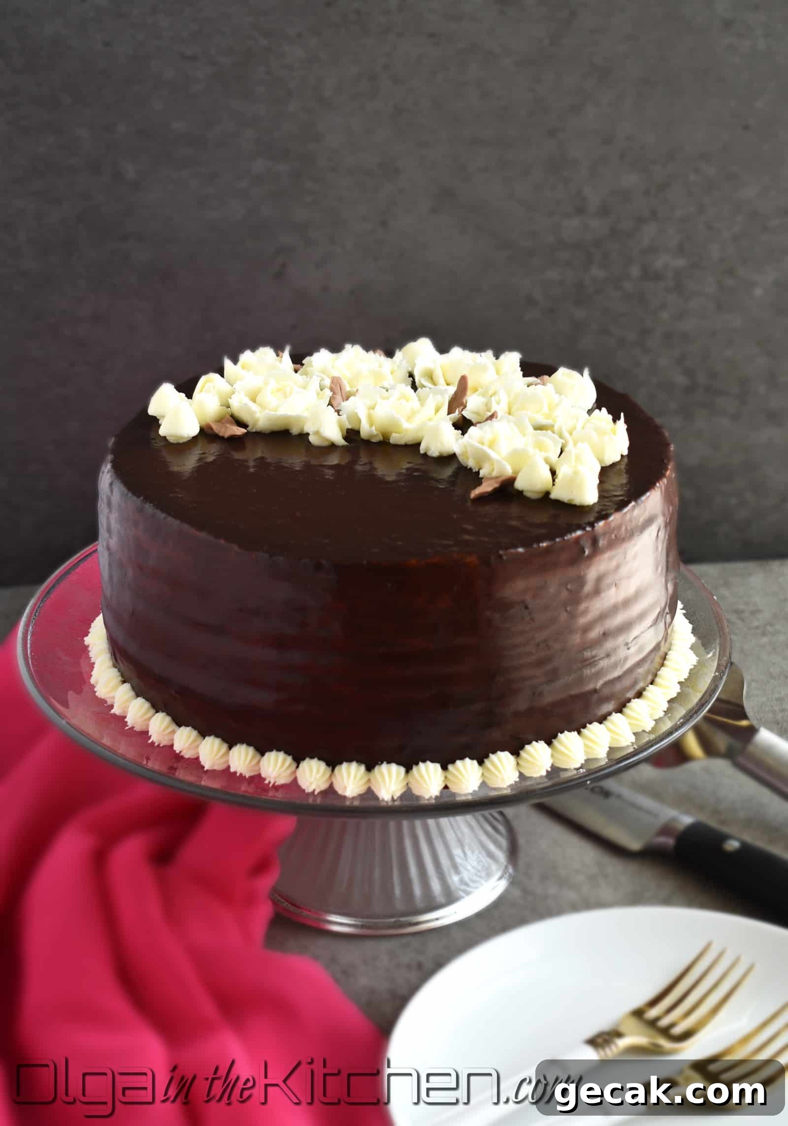 Chocolate Spartak Cake: chocolate-y, 9-layer cake, filled with sour cream frosting, topped with chocolate ganache and decorated with buttercream flowers! | olgainthekitchen.com
