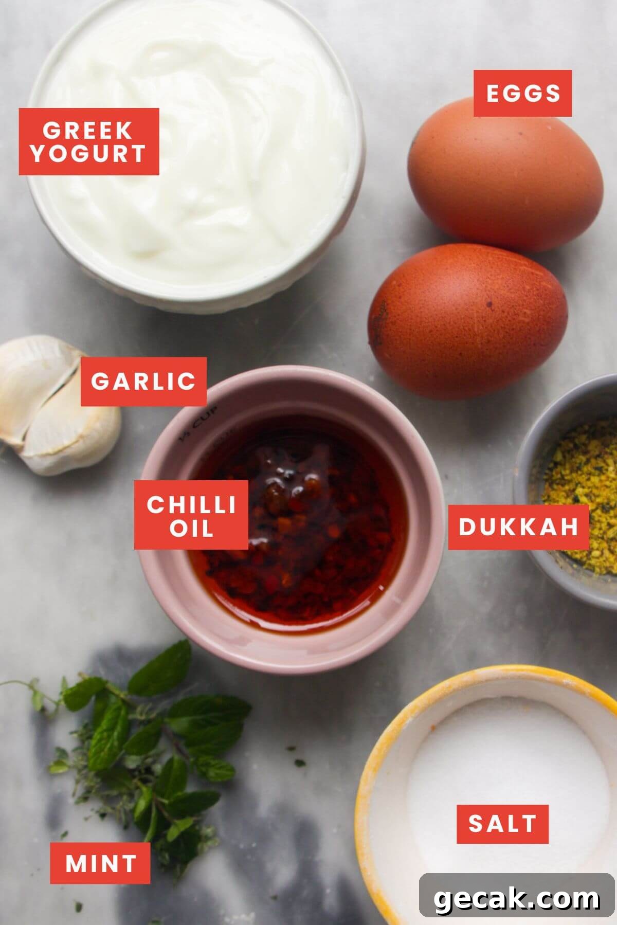 Turkish-Style Poached Eggs with Tomato and Yogurt Sauce 3 Ingredients for Turkish eggs laid out on a grey marble background and labelled.
