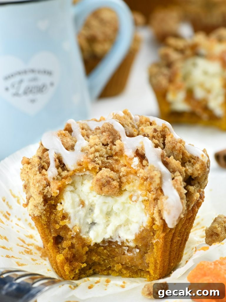 Bitten cream cheese pumpkin muffin on baking paper