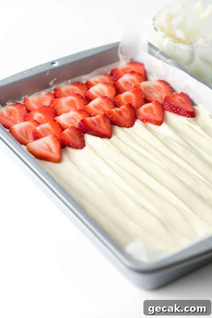 Pan of strawberry fruit pizza with cream cheese frosting