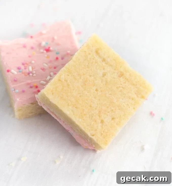 bottom of frosted sugar cookie bars with pink frosting and sprinkles
