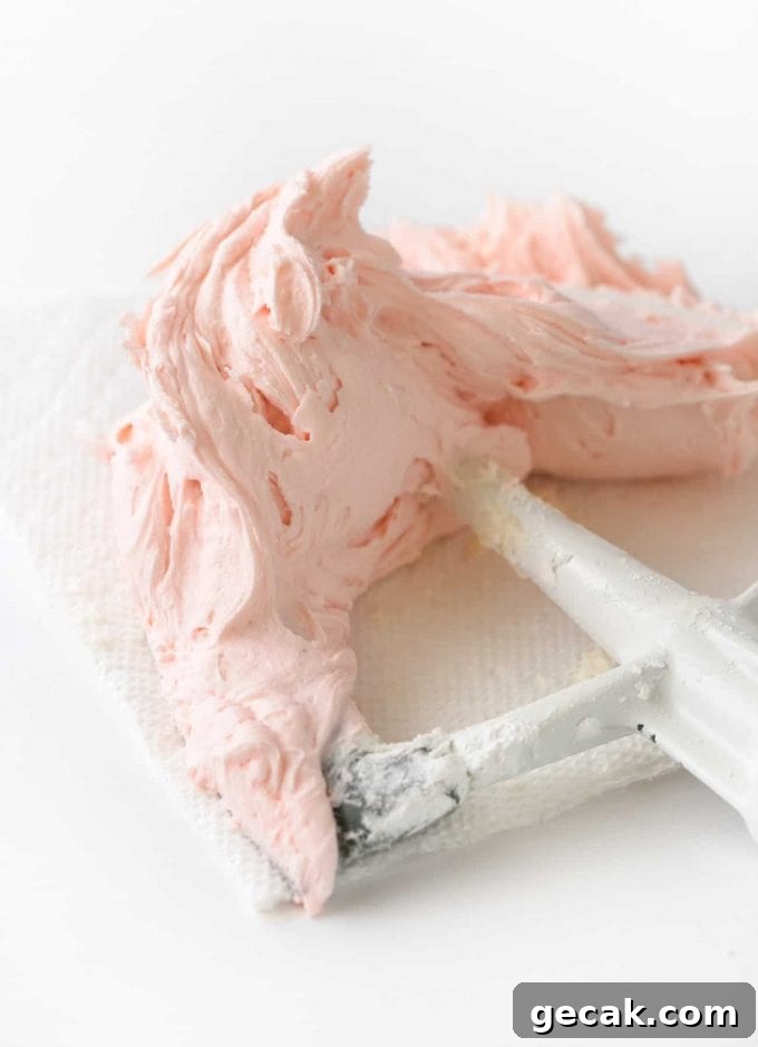Pink buttercream frosting on kitchenaid paddle