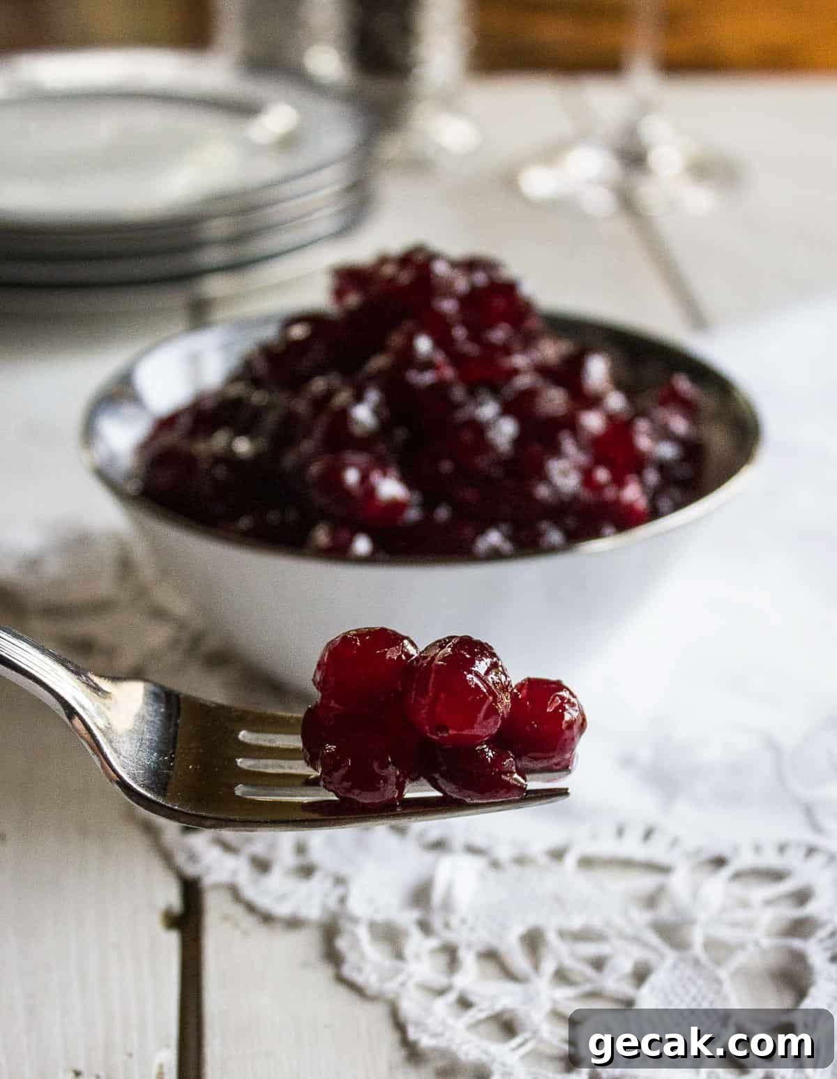 A fork with a bit of cranberry sauce on the tines.