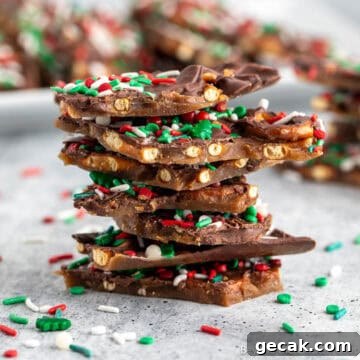 Pieces of chocolate caramel pretzel bark stacked together.