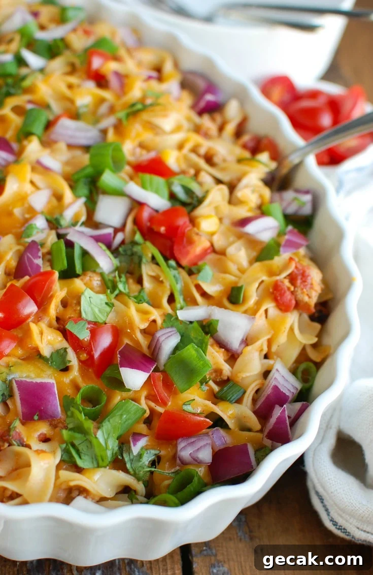 Easy Mexican Noodle Casserole with No Yolks Noodles and colorful toppings.