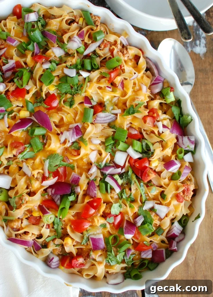 Casserole topped with melted cheese and fresh garnishes.