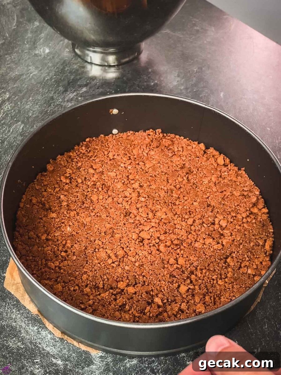Pack the crushed Biscoff cookies and butter mixture.