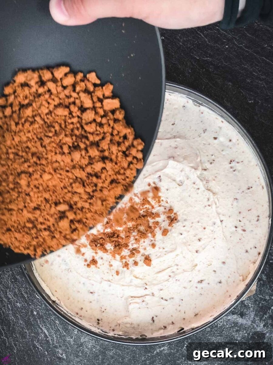 Add the Biscoff cookie crumbs on top of the cream cheese filling.