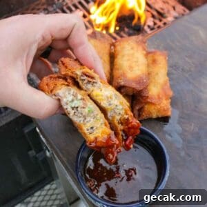 The jalapeño popper egg rolls sliced and dipped in the sauce.