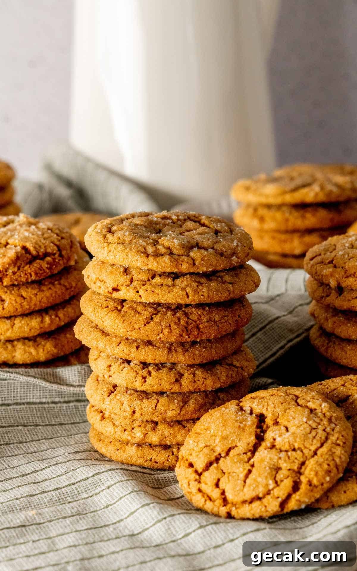 A stack of old fashioned molasses cookies with crackled tops.