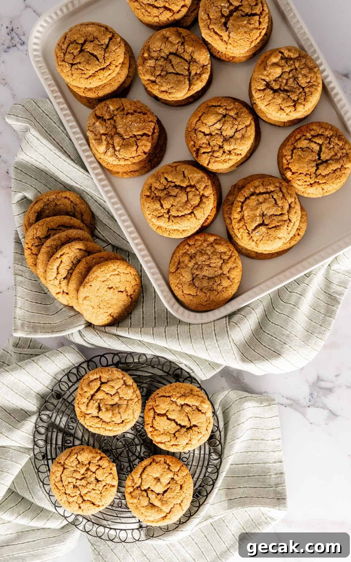 Birds eye view of old fashioned molasses cookies on a white serving tray and a cooling rack.
