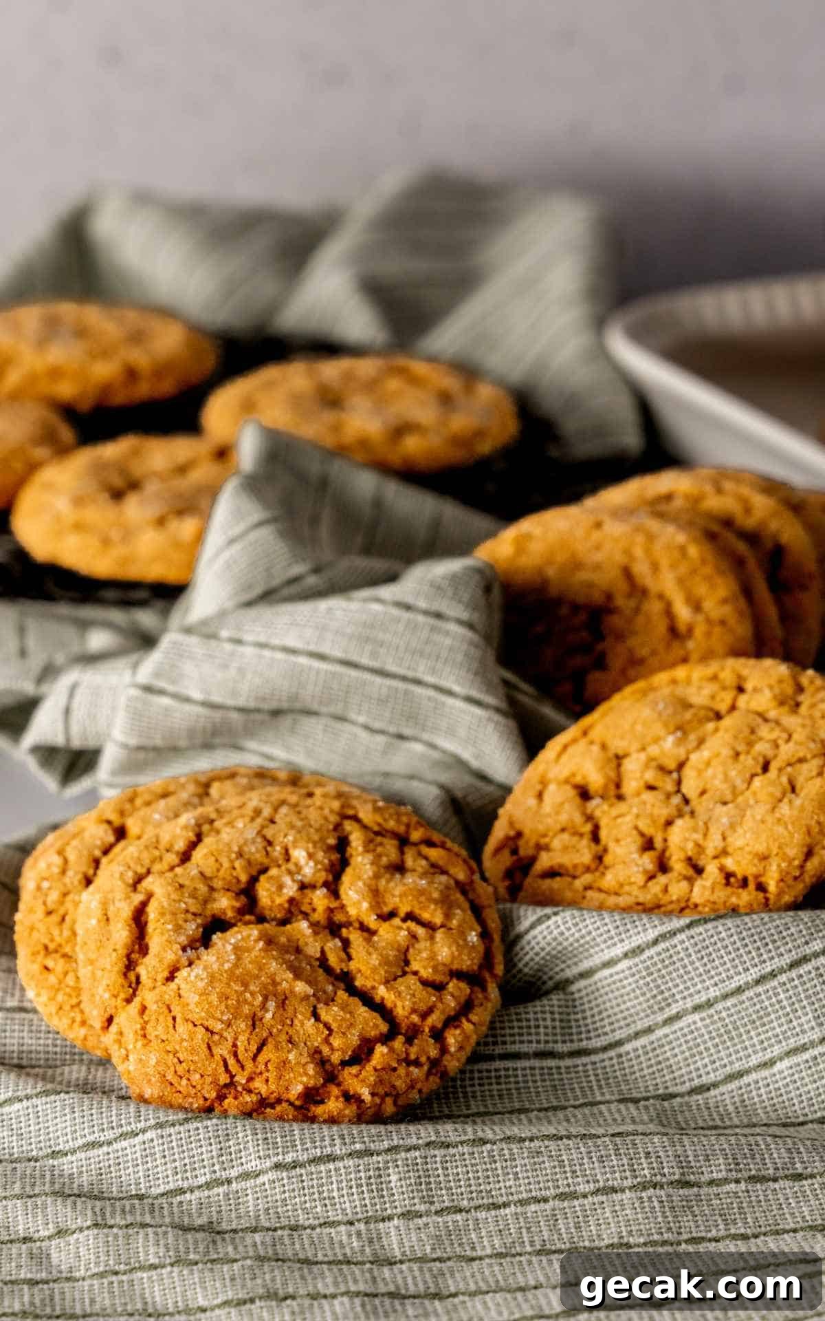 Soft and chewy molasses cookies on a linen napkin.
