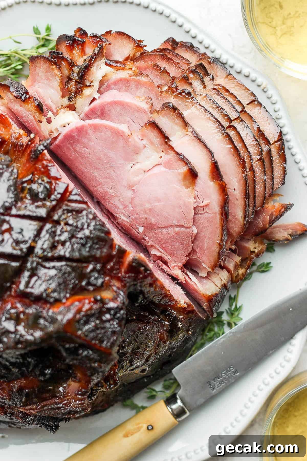 The ham cut into slices on a large plate.