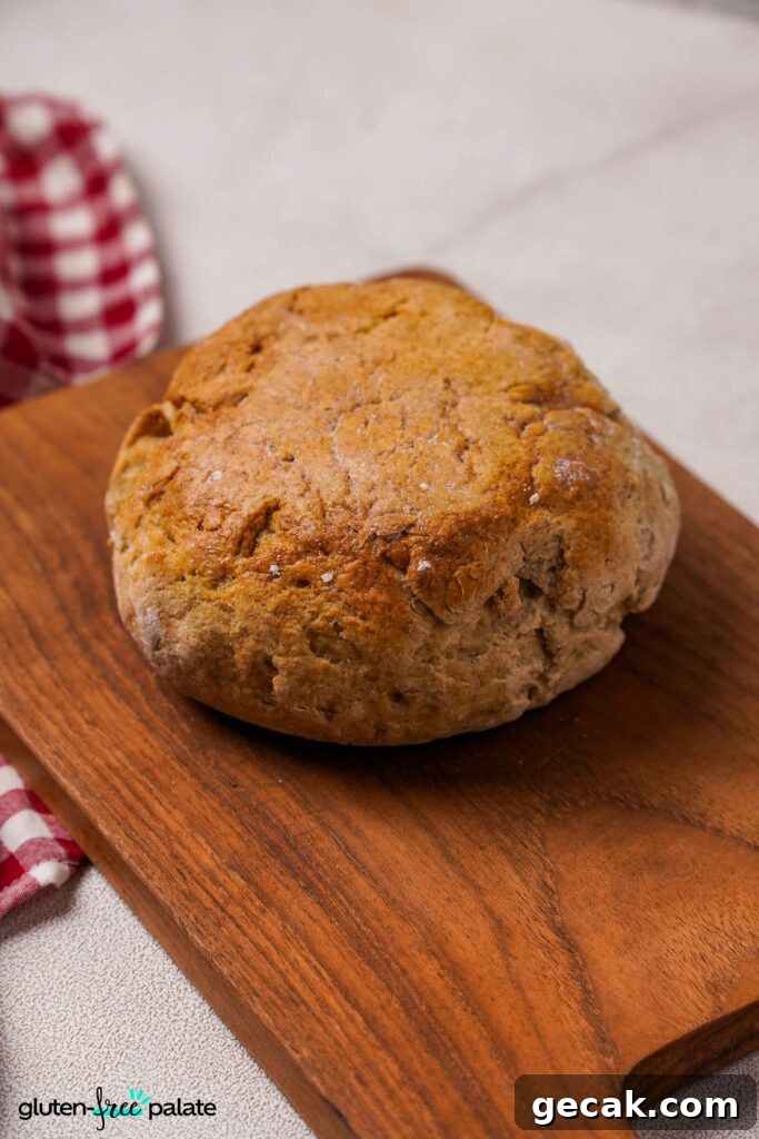 Gluten-free Artisan bread unsliced on a bread board.