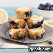 A pyramid of lemon blueberry cheese danish muffins with blueberries and lemon slices in the background.