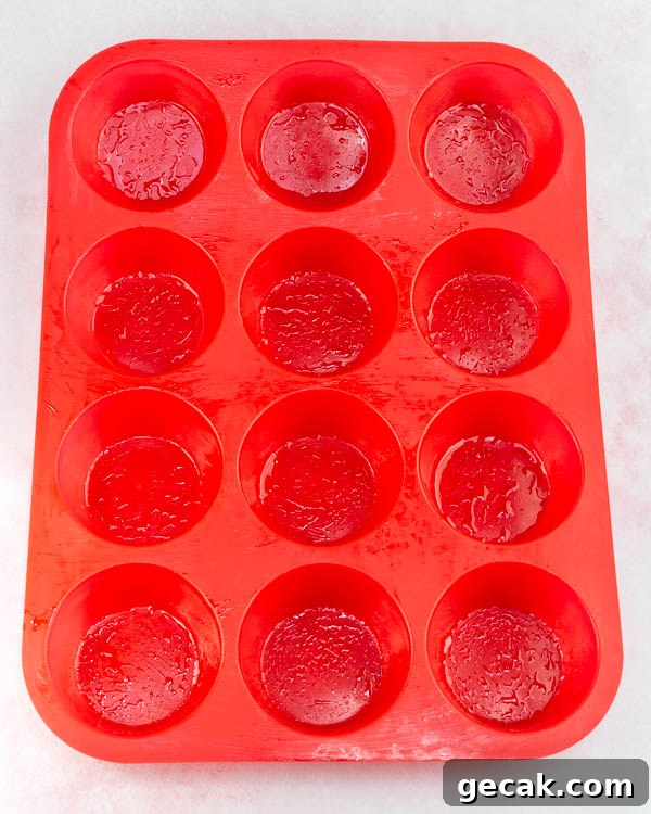 Greasing the muffin pan.