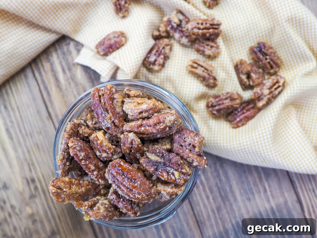 Bourbon Candied Pecans with Sweet & Spicy Glaze 2 a jar of candied pecans and a yellow and white plaid napkin.