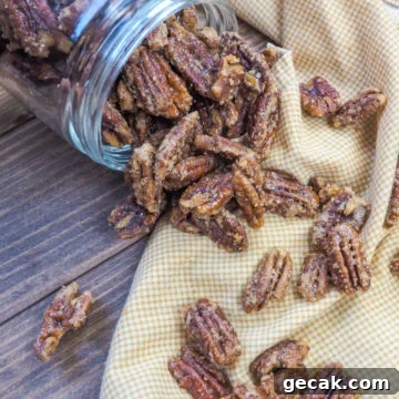 Bourbon Candied Pecans with Sweet & Spicy Glaze 3 a spilled jar of candied pecans on a white and yellow napkin.