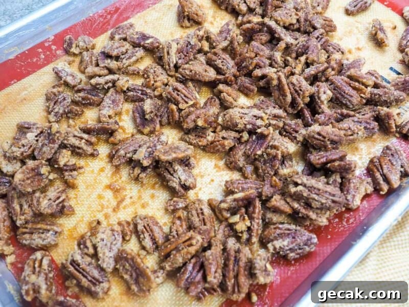 Bourbon Candied Pecans with Sweet & Spicy Glaze 4 a zoomed in image of a tray of candied pecans.