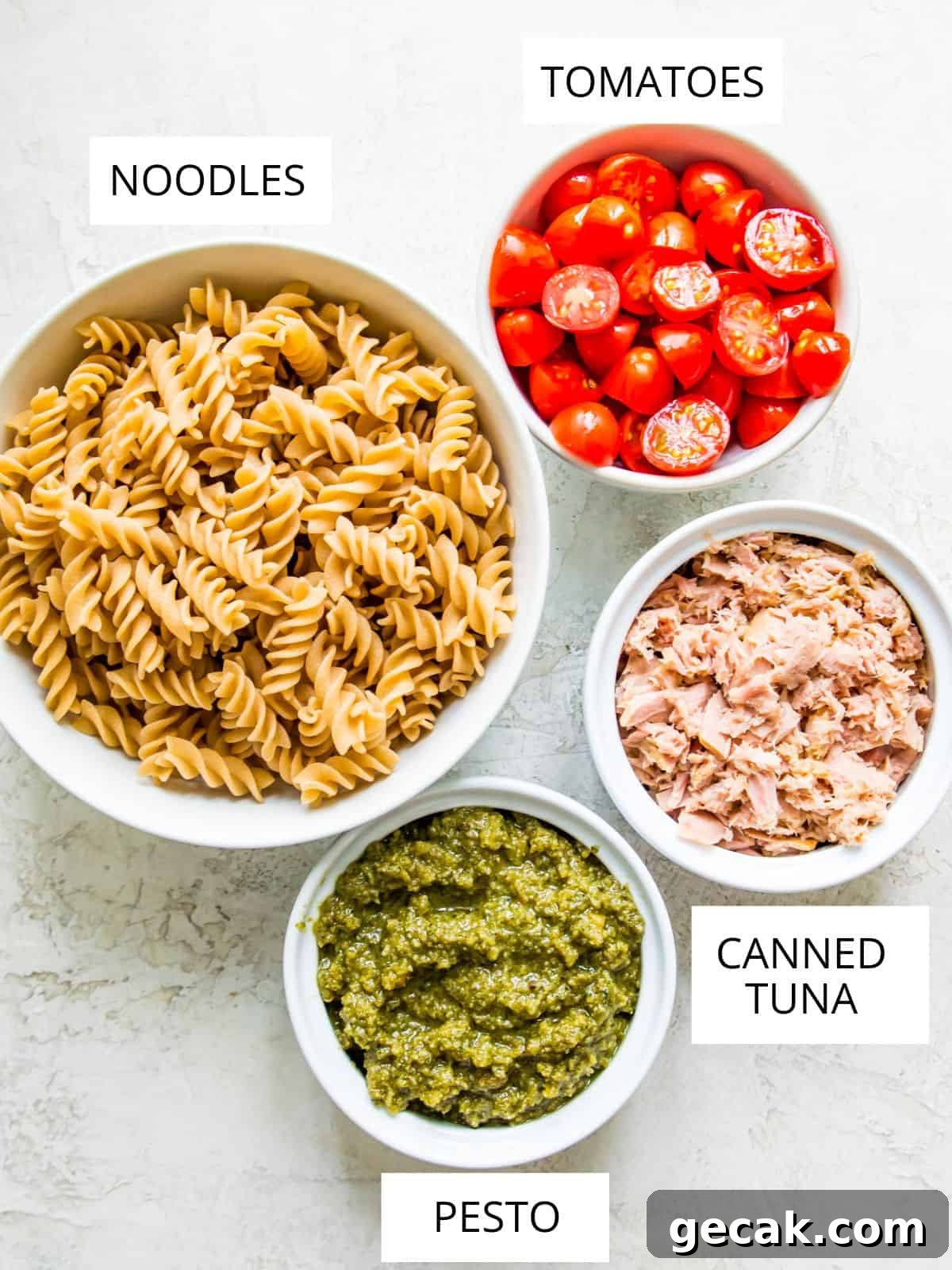 The ingredients needed for making tuna pasta pesto in small bowls.