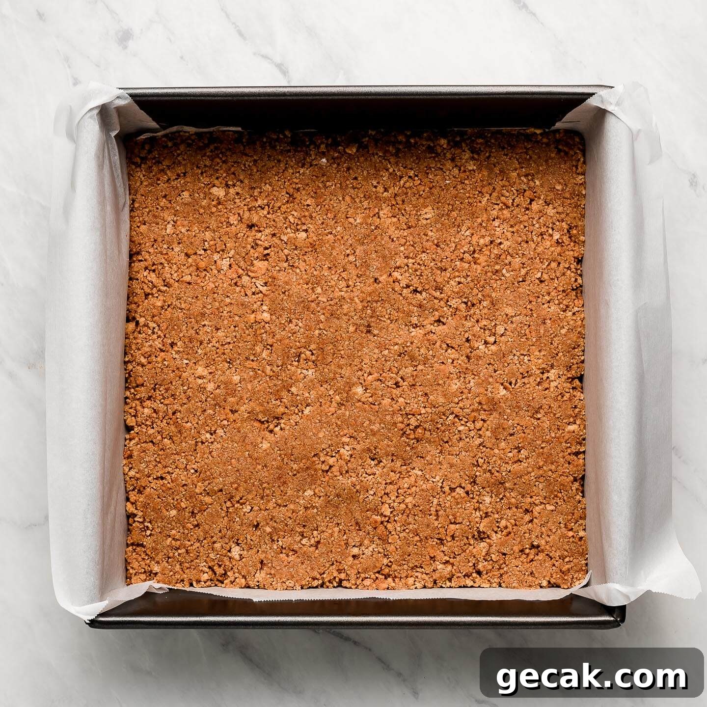 Graham cracker crumbs pressed into the bottom of the pan.